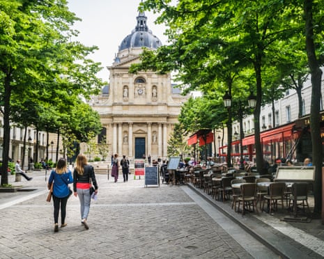 Two young women walk towards the Pantheon, Sorbonne University, in Paris