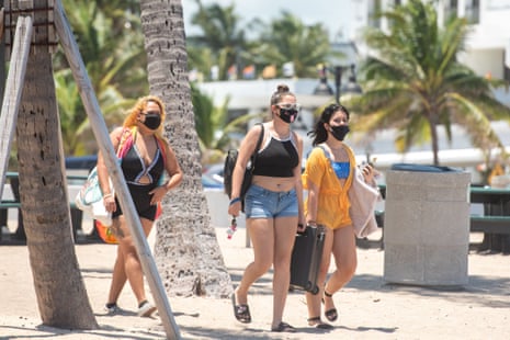Beachgoers enjoy a sunny day on the beach in Fort Lauderdale, Florida despite a record high number of new Covid-19 cases in the state this week, on 25 July, 2020.