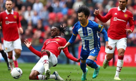 Manchester United’s Aaron Wan-Bissaka snatches the ball from Kaoru Mitoma of Brighton
