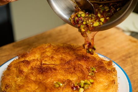 The kataifi pie is drizzled with oregano honey with pistachios and lemon