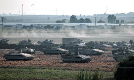 Israeli troops in tanks and other armoured vehicles amass in a field near the southern Israeli city of Ashkelon