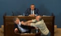 Mamuka Mdinaradze is punched in the face by opposition MP Aleko Elisashvili.