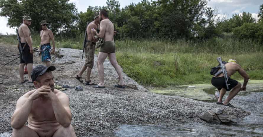 Ukrainian servicemen bathe in a stream in the Fedorivka frontline, Ukraine.