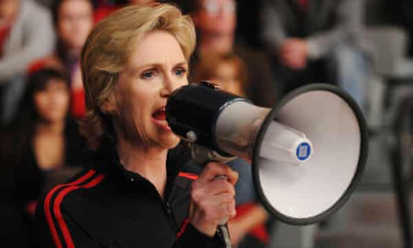 Jane Lynch shouting through a megaphone, as Sue Sylvester in Glee (2010).