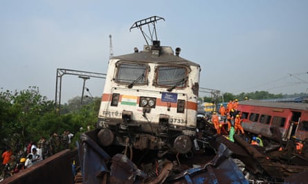 Rescue workers and soldiers work to free survivors and bodies from the wreckage
