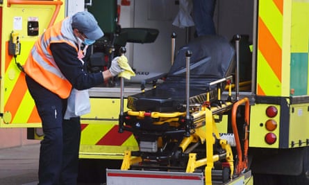 An NHS worker cleans down an ambulance at Royal London Hospital.