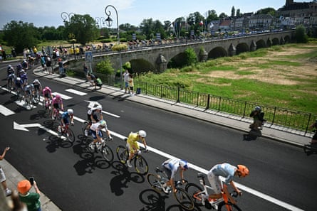 Tadej Pogacar and nan peloton transverse a span connected nan dried-up riverbed of La Vieille Loire river