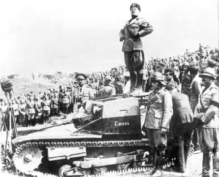 Benito Mussolini stands on a tank to address troops during the second world war