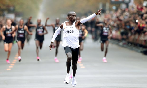 Kenya’s Eliud Kipchoge, wearing Nike’s previous ‘gamechanging’ running shoes, crosses the line during his successful attempt to run the marathon in under two hours in Vienna.