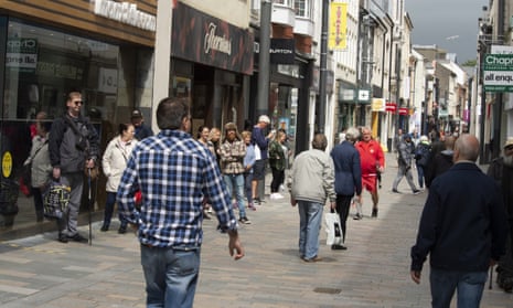 People shop in the high street in Douglas, Isle of Man.