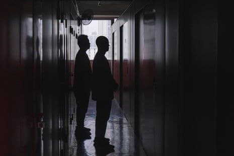 Yip Shun-Ting Carbon (left) and father Yik Ka-Kui (second from left) stand solemnly together inside the unit.
