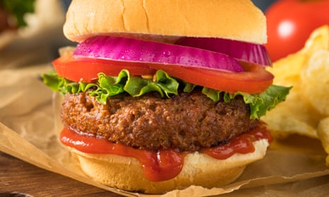 A meat-free burger with lettuce, tomato and onion.