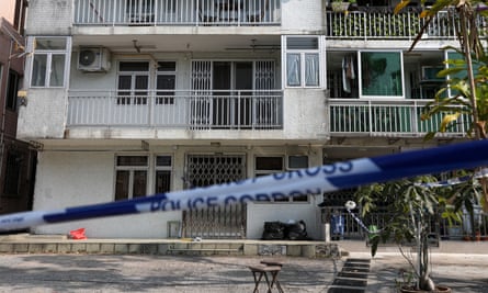 Police guard a home where remains suspected to belong to Hong Kong model were found.