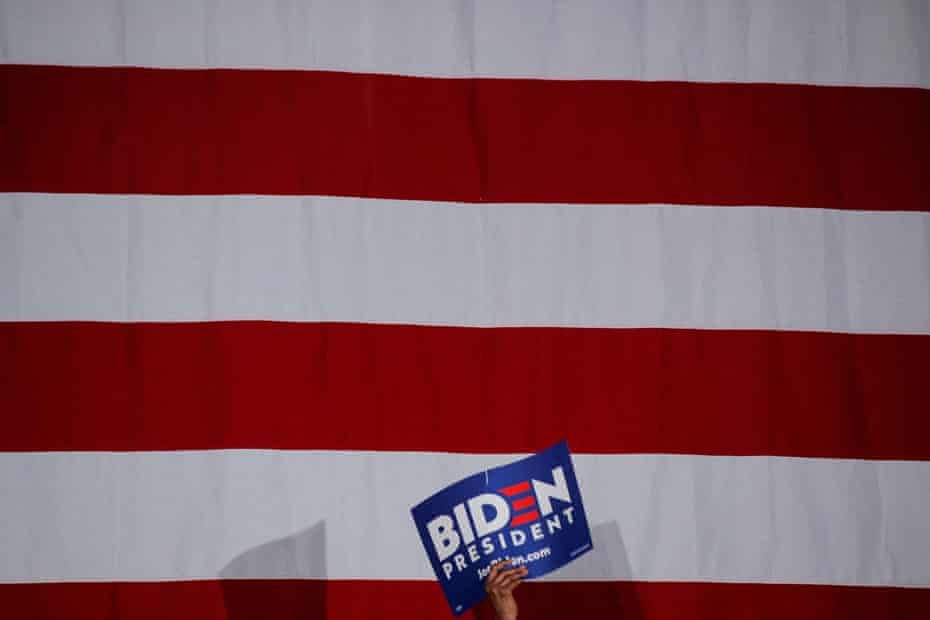 A supporter holds a sign as Biden speaks during a campaign stop in Tougaloo, Mississippi.