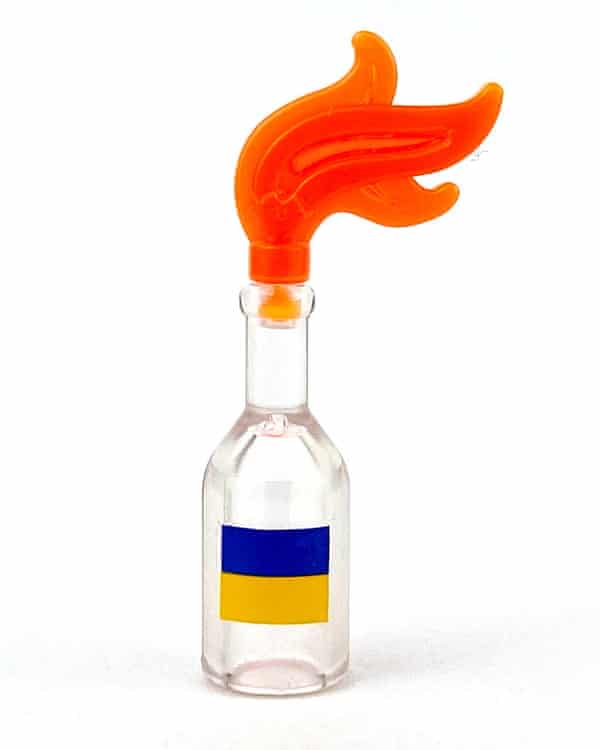 Chicago artist raises funds for Ukraine by selling Zelenskiy Lego figures | Volodymyr Zelenskiy 1 a tiny toy bottle with a yellow and blue flag topped with a plastic orange flame