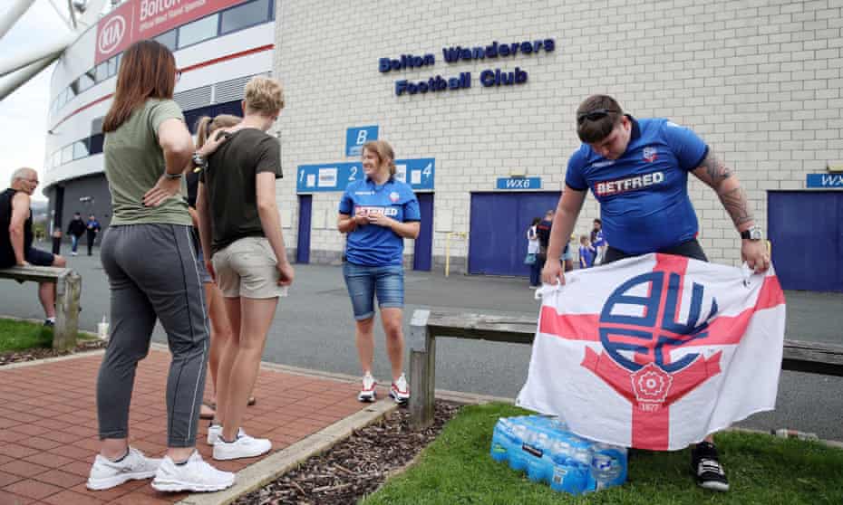 Fans gather at the University of Bolton Stadium to wait for news.