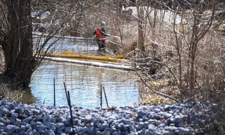 A worker cleans up the site following the derailment of a train carrying hazardous waste in East Palestine, Ohio.