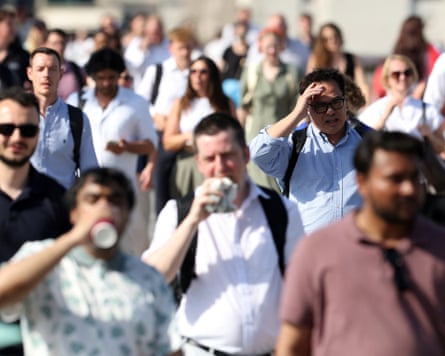 A stream of commuters walking in the hot weather