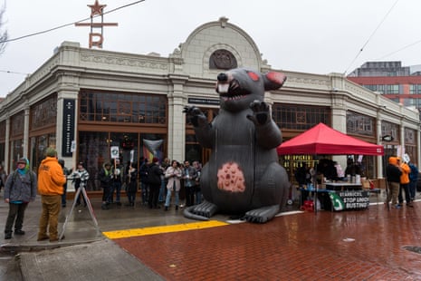 Starbucks employees on strike outside the flagship Capitol Hill cafe location with a giant inflatable rat in December 2022.