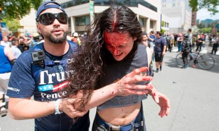 A Trump supporter assists an injured man.