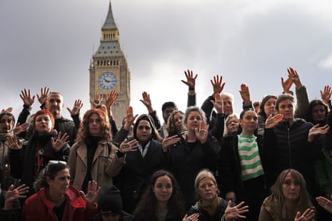 People take part in a vigil organised by Medical Aid for Palestinians at Parliament Square, central London