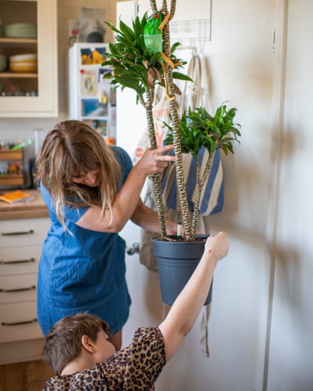Elle and Claire inspect a plant’s roots.