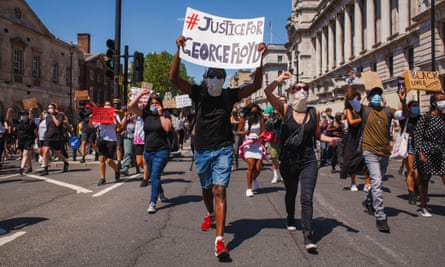 Activists march along Whitehall, London, while holding placards during the George Floyd demonstration.