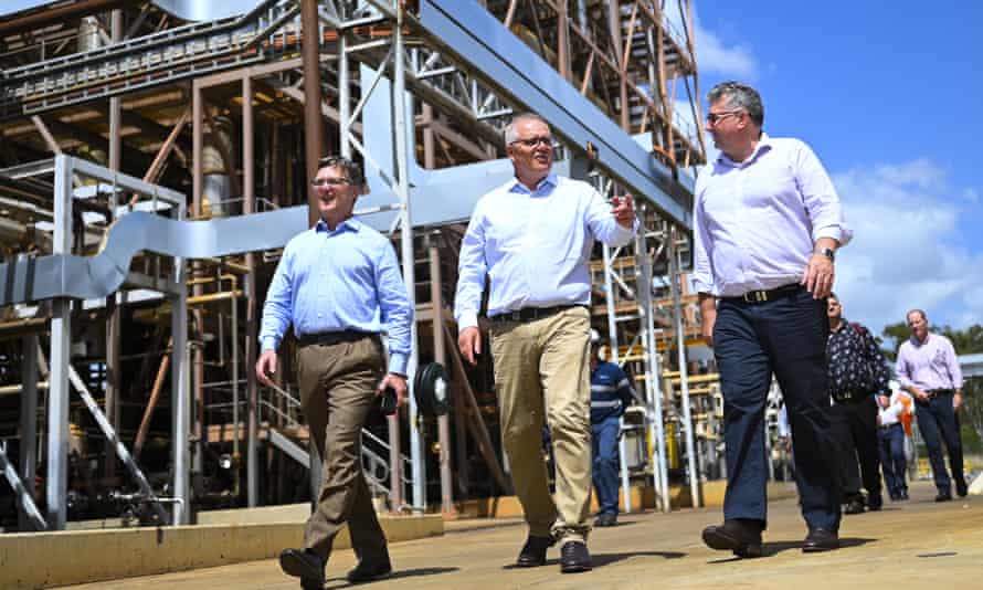 Prime Minister Scott Morrison (centre) visits. an oil refinery in Gladstone, Queensland, in January.