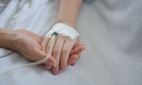 mother holding child's medicated hand.