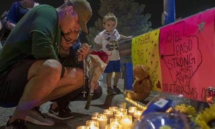 Rene Aguilar and Jackie Flores pray at a makeshift memorial for the victims of Saturday’s mass shooting at a shopping complex in El Paso, Texas, 4 August 2019.
