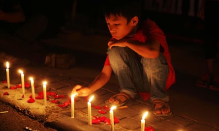 A boy lights candles to show solidarity with the victims of last week’s terror attacks in Jakarta, Indonesia.