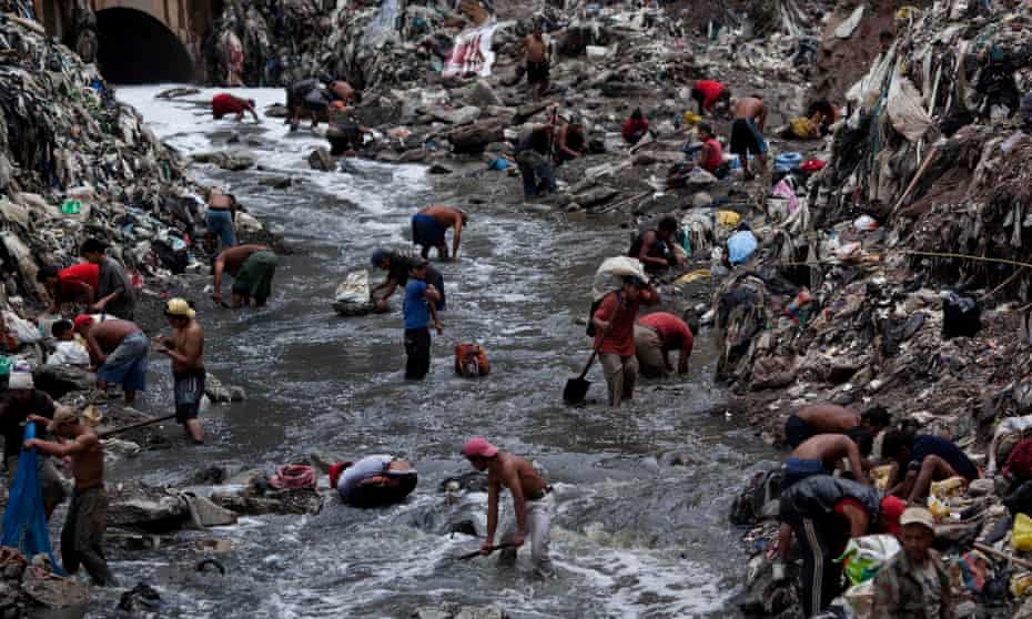 People scavenge at a garbage dump in Guatemala City.
