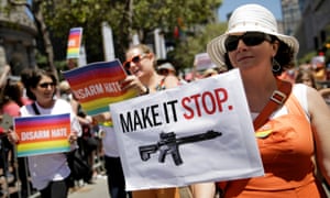 A California woman holds a sign advocating for gun control.