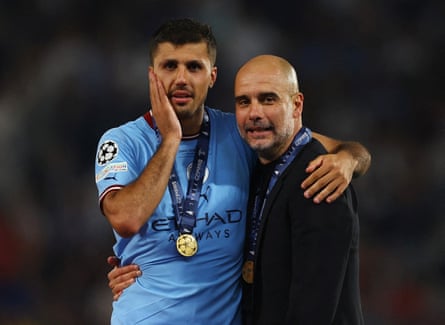 Rodri and manager Pep Guardiola enjoy Manchester City’s Champions League triumph on the pitch in 2023.