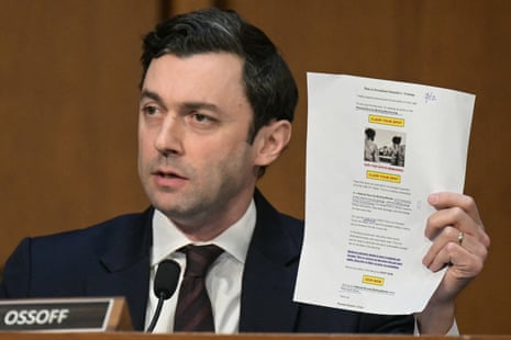 Jon Ossoff holds up a fundraising email from Donald Trump during a Senate committee hearing on Wednesday.
