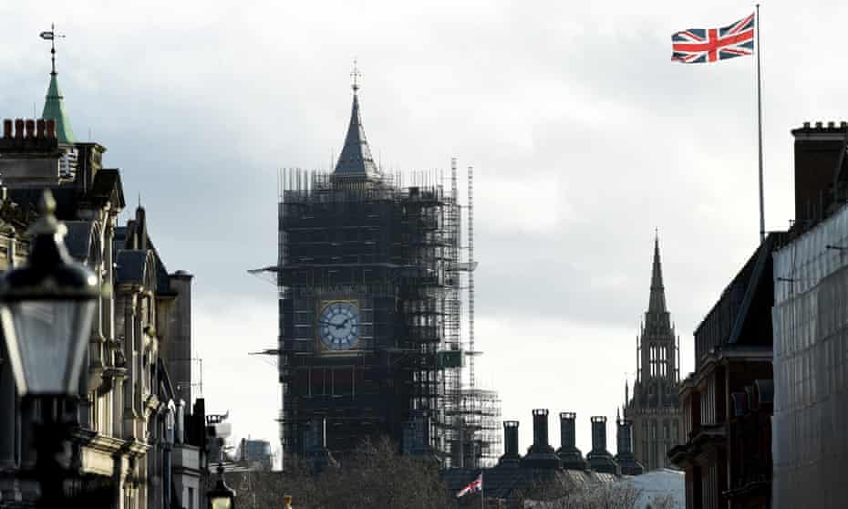Big Ben covered in scaffolding, Union Jack flag nearby