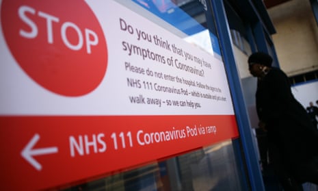 A sign directing people with symptoms of Covid-19 to an isolation unit at St Mary’s hospital in London in March 2020