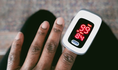 Close-up of a hand using a pulse oximeter to check blood oxygen saturation level and heart rate
