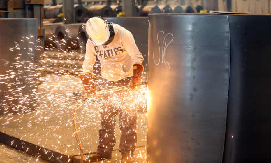 An employee cuts a sample from a roll of coiled steel at Liberty House Group's mill in Newport, south Wales