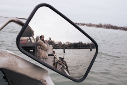 A woman reflected in the rear-view mirror of a vaporetto