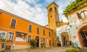 painted walls on a cobbled lane in the medieval town of Dozza, near Bologna.