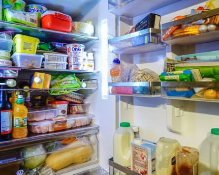 A fridge full of food. Bottles, packages, groceries and foods of different types.2AM710T A fridge full of food. Bottles, packages, groceries and foods of different types.