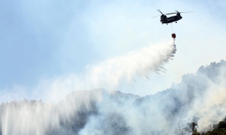 A Chinook helicopter douses a wildfire in Malakassa, near Athens on Saturday.
