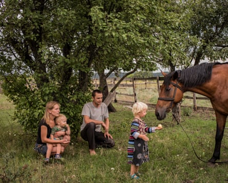 Olha and Mikola Grinik with their son, Kirill, daughter, Miroslava, and horse, Lastochka (Swallow), at their home in Avdiivka, 2018
