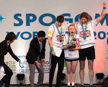 The team on a stage with the trophy.