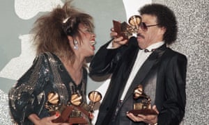 Tina Turner shares a laugh with Lionel Richie as they celebrate their wins during the Grammy Award show in Los Angeles on 27 February 1985