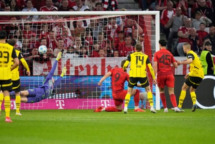 Dortmund’s Waldemar Anton, right, scores his side’s late equaliser in Munich
