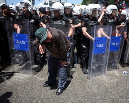 Turkish riot police stand guard in a line