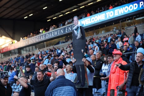 Coventry City fans cheer for their team and hold up a cardboard cutout of manager Frank Lampard prior to kick off at Blackburn.