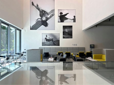 A space in a museum with large black-and-white photographs on the wall and seating below